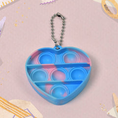 A hand holding a mini fidget keychain, highlighting its small size and easy grip for on-the-go stress relief.