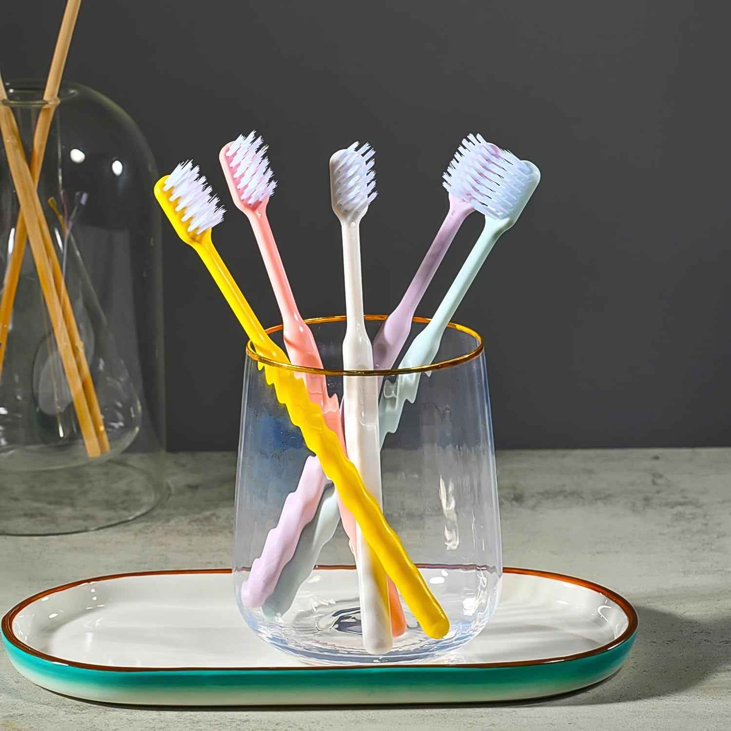 Soft plastic toothbrush set with vibrant colors and a portable round box, perfect for family oral hygiene.