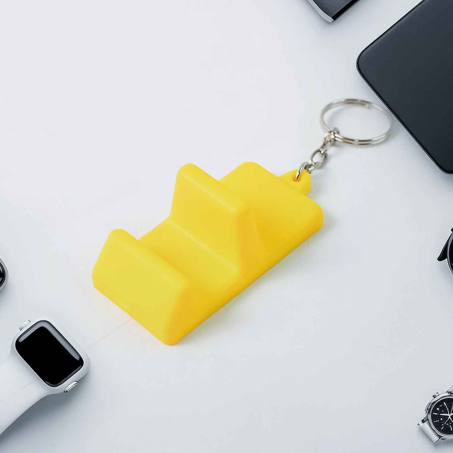 Mobile stand keychain held on finger showing compact size