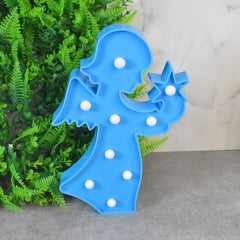 LED angel night light creating a soft, romantic ambiance in a beautifully decorated room.