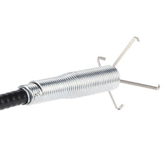 User demonstrating the flexible drain cleaning brush in a kitchen sink.