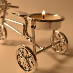 Close-up of tealight candle burning on decorative cycle stand holder