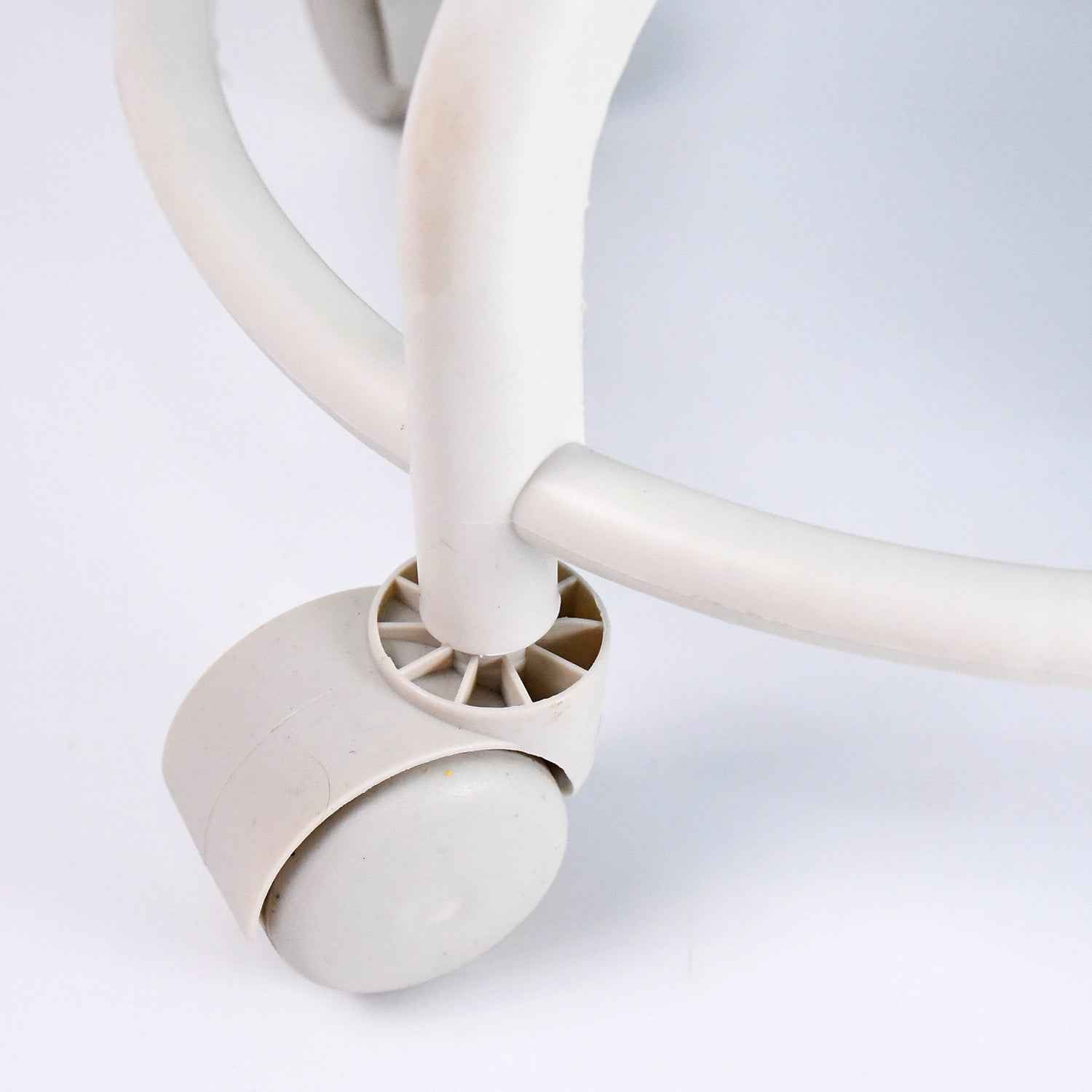 Side view of low rolling stool showing cushioned seat and sturdy wheels