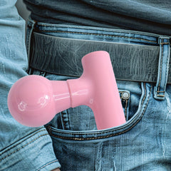 Hand holding the black mini massager, demonstrating ease of use.