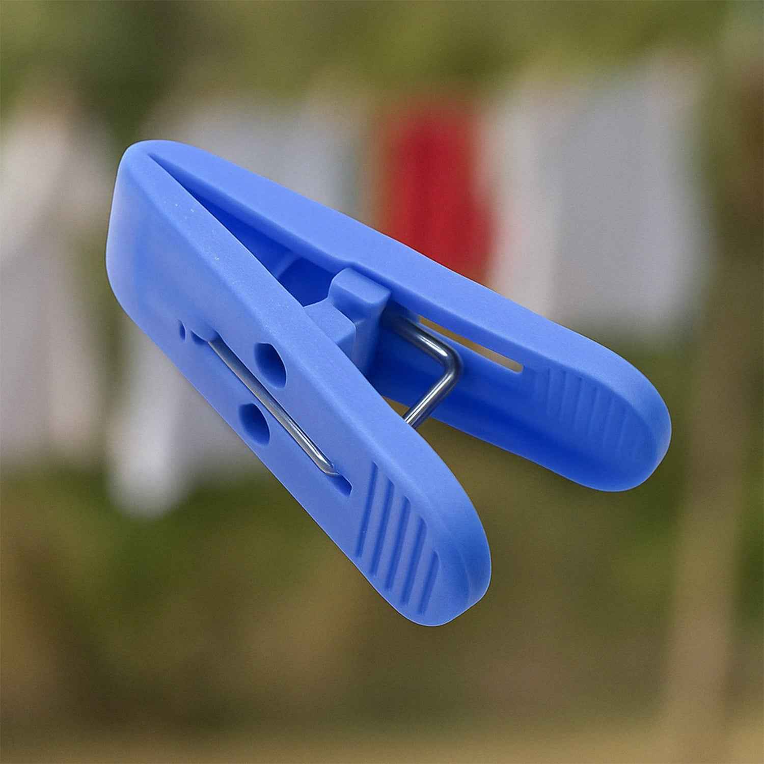 Multicolor plastic cloth drying clips securely holding laundry on a clothesline.