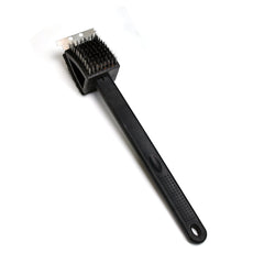 Black silicone toilet brush with its draining holder, ready for use in a modern bathroom.
