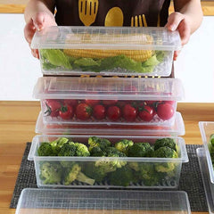 Clear plastic freezer storage container with a removable drain plate, ready for vegetables.