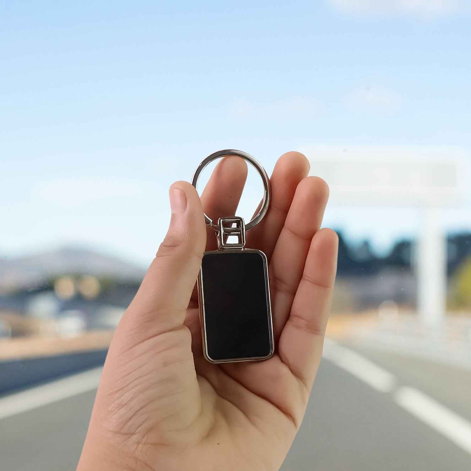 Sleek rectangular metal keychain with polished black and silver edges