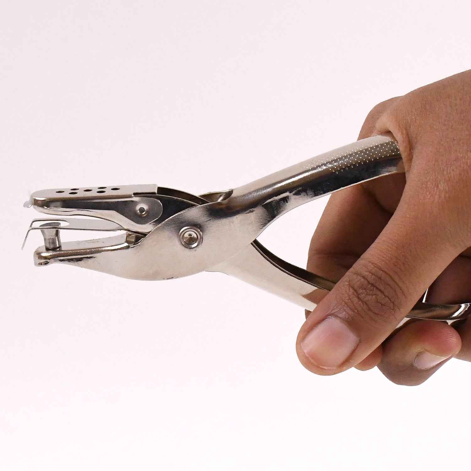 Detailed view of the single hole puncher's spring mechanism for smooth operation.