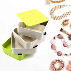 Elegant 4-layer Rotating Jewelry Box in white, ideal for storing earrings and rings.