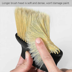 Ergonomic cleaning brush easily dusting a car's air outlet, showing its comfortable grip and effective reach.