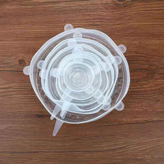 Hand stretching a flexible silicone lid to fit a large bowl.
