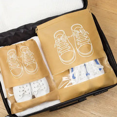 Organivo waterproof shoe bag with beach essentials storage on a sandy beach.