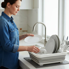 Dish drying rack with drain tray placed on kitchen sink