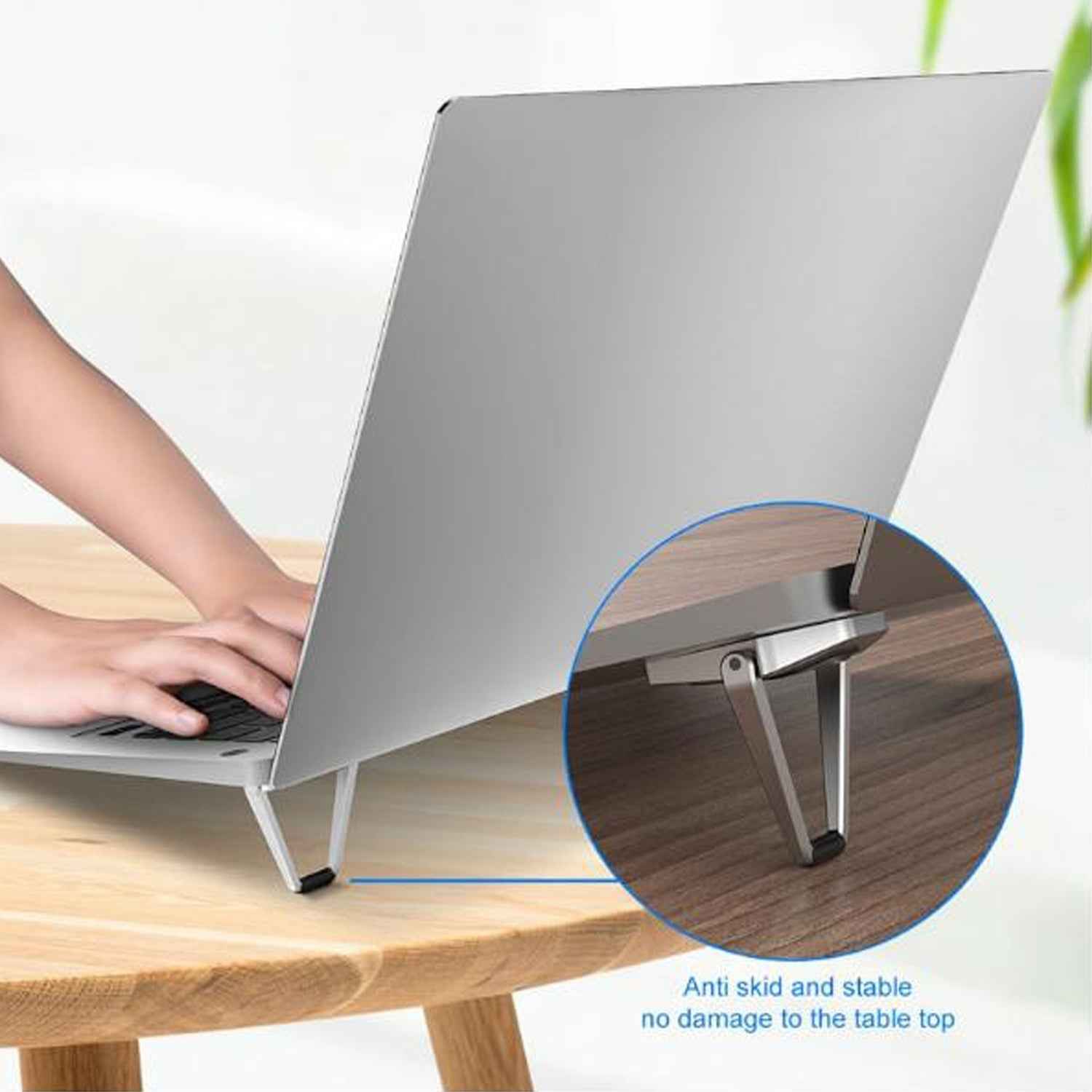 Close-up of the durable metal construction and non-slip rubber pads of the foldable laptop stand.