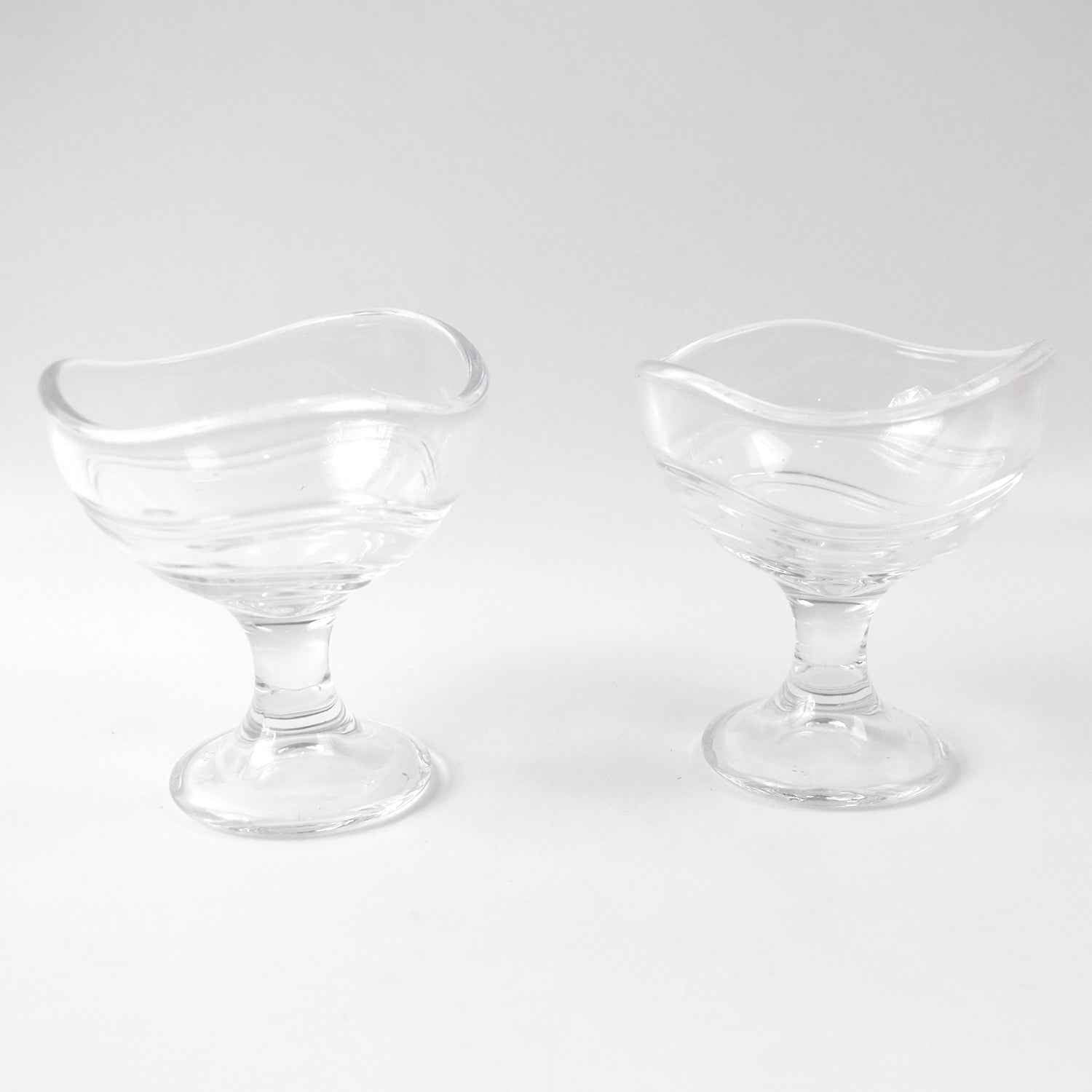 Clear glass dessert bowl highlighting its sturdy footed base.