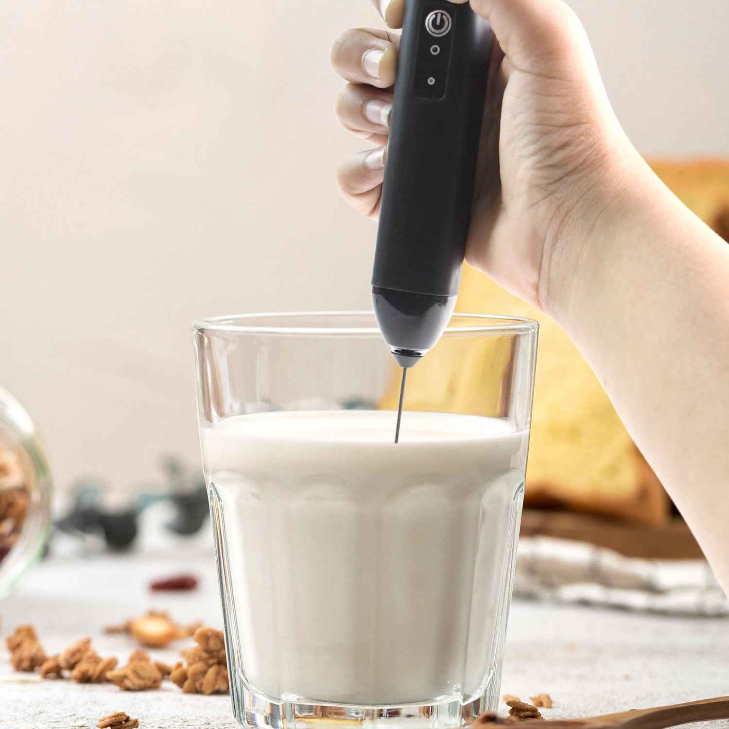 Closeup of stainless steel whisk on electric handheld milk frother