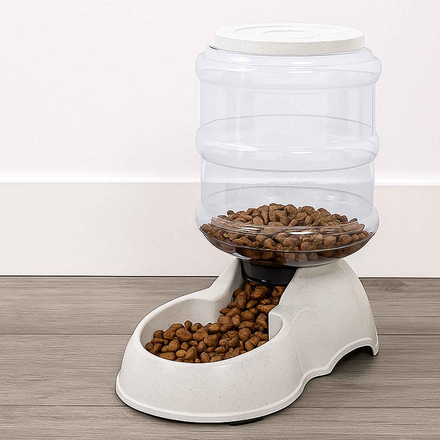 White automatic pet food dispenser with clear food storage bottle for dry kibble