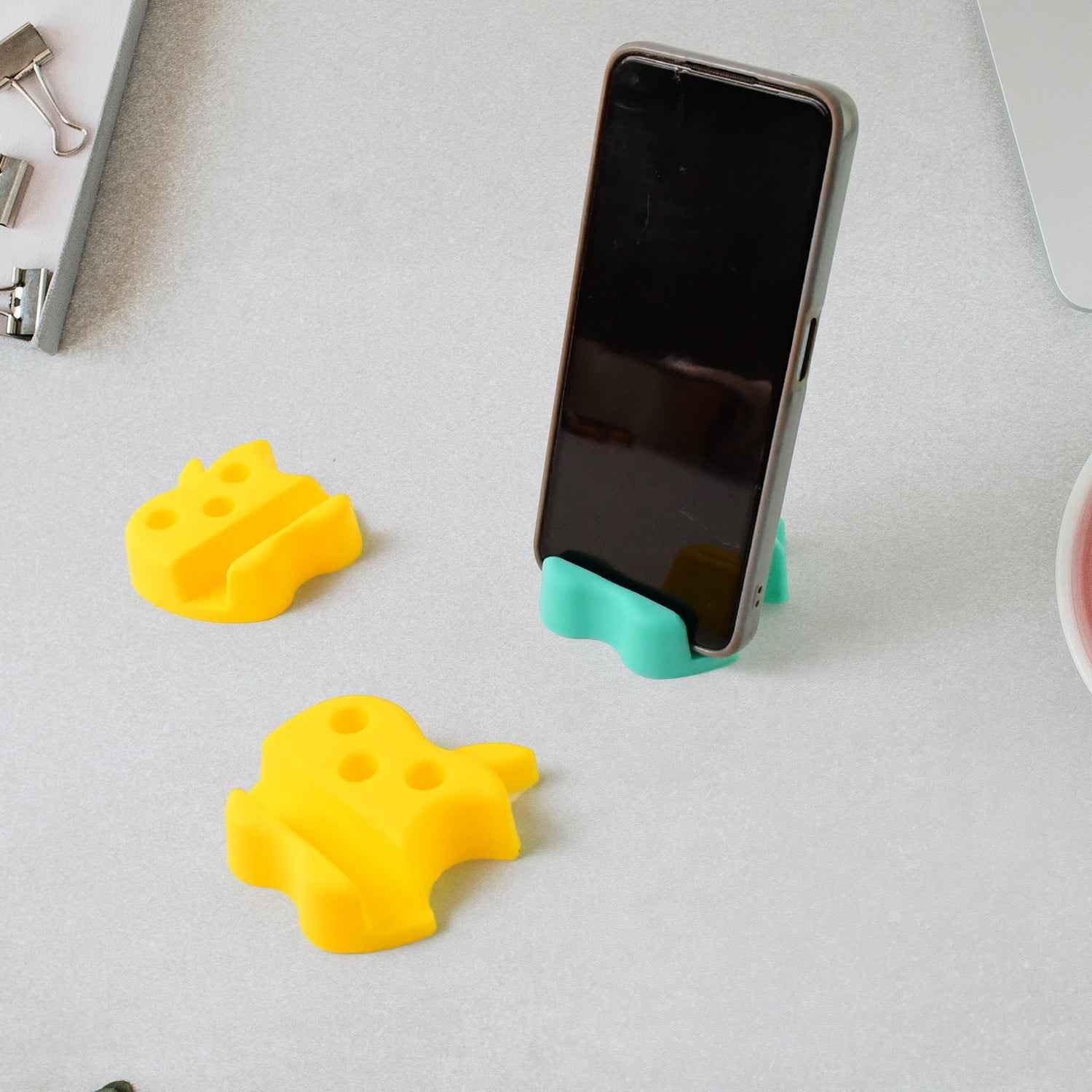 Close-up view of apple nest stand featuring pen storage and phone holder