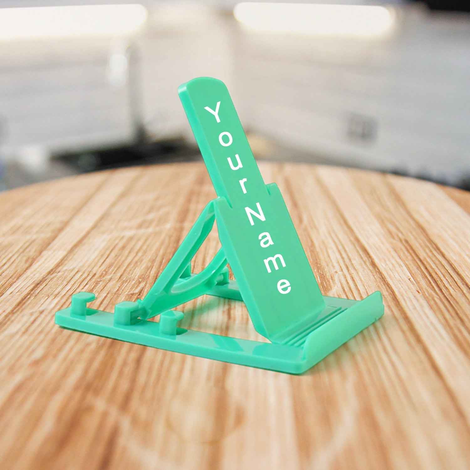 Sturdy plastic mobile phone stand with adjustable tilt in use