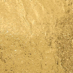 Close-up of a self-adhesive golden kitchen foil sticker roll.
