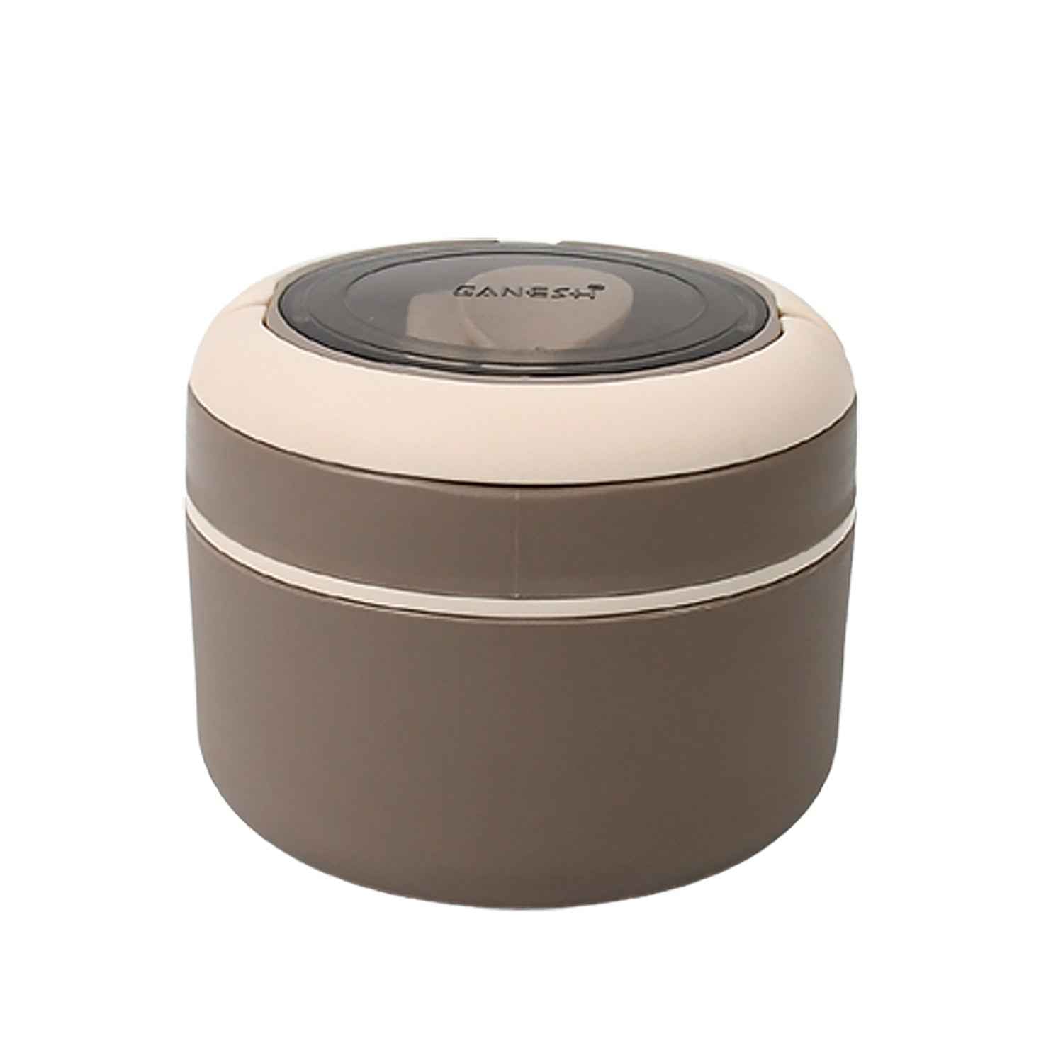 The Ganesh food container with spoon displayed on a table, emphasizing its complete meal solution.