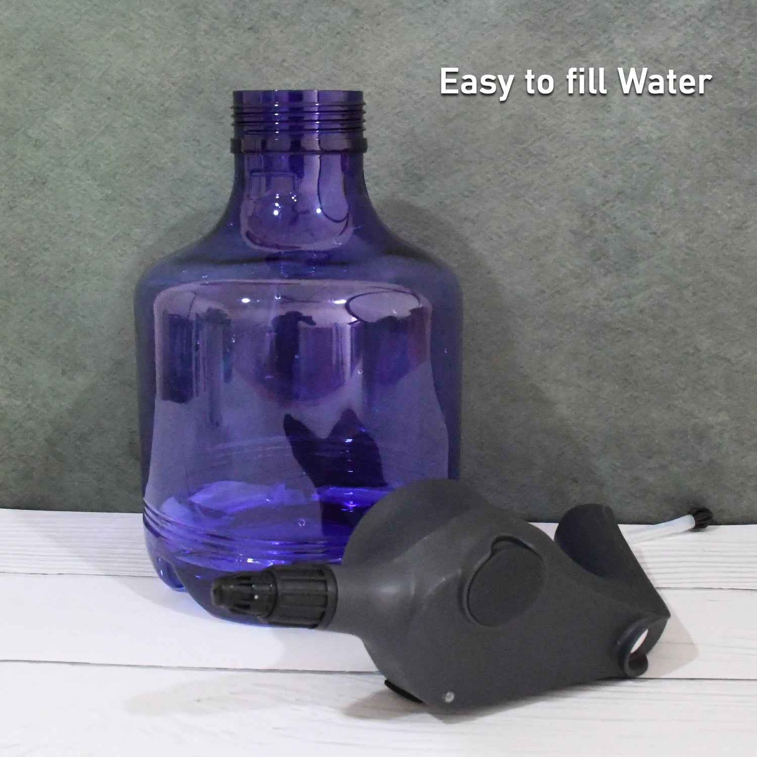 An electric garden sprayer gently misting a lush green plant for efficient and even watering.