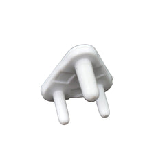 A child's hand reaching towards a covered electrical socket, demonstrating the protection of baby socket covers.