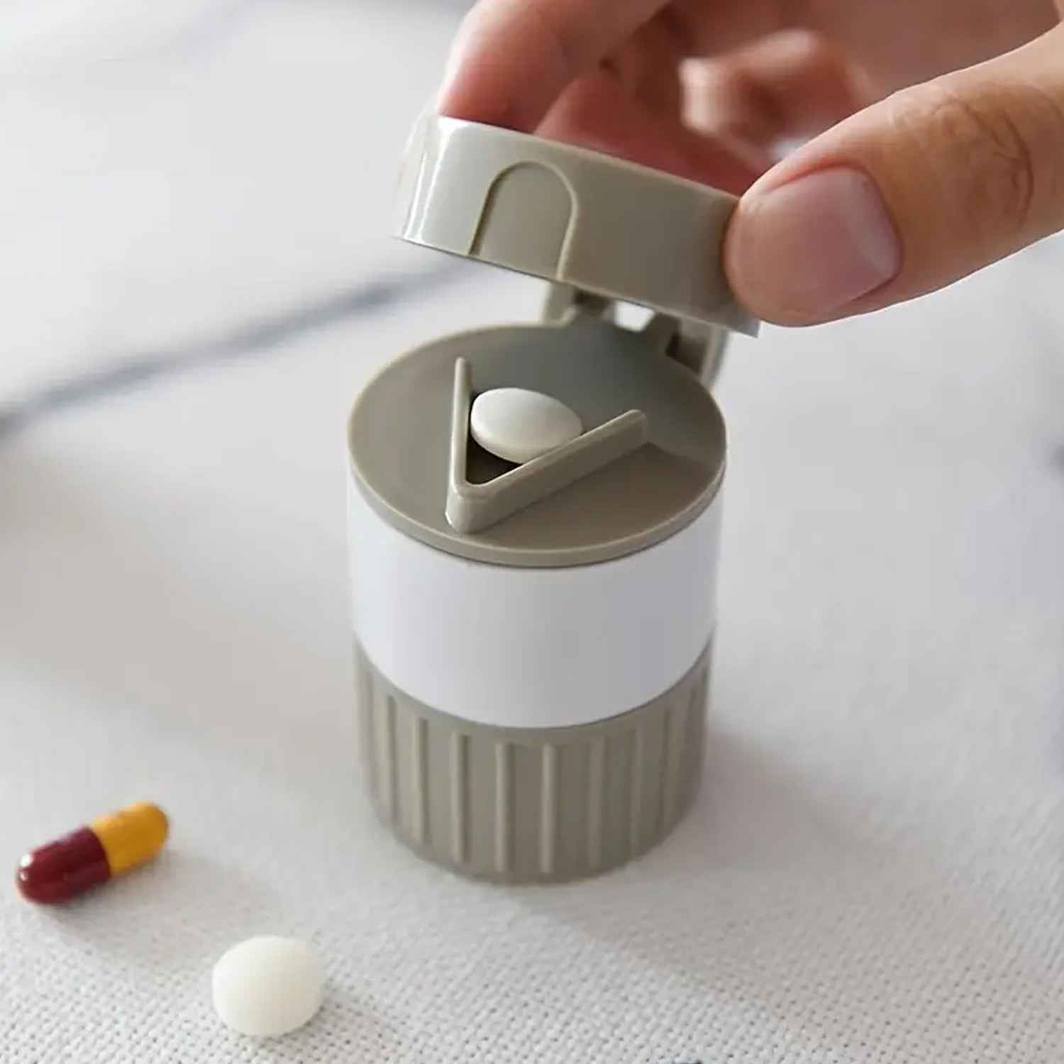 Opened Organivo medicine cutter revealing the pill cutting blade and storage areas.