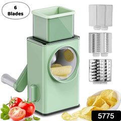Close-up of the mandoline slicer's rotary handle and food pusher for safe operation.
