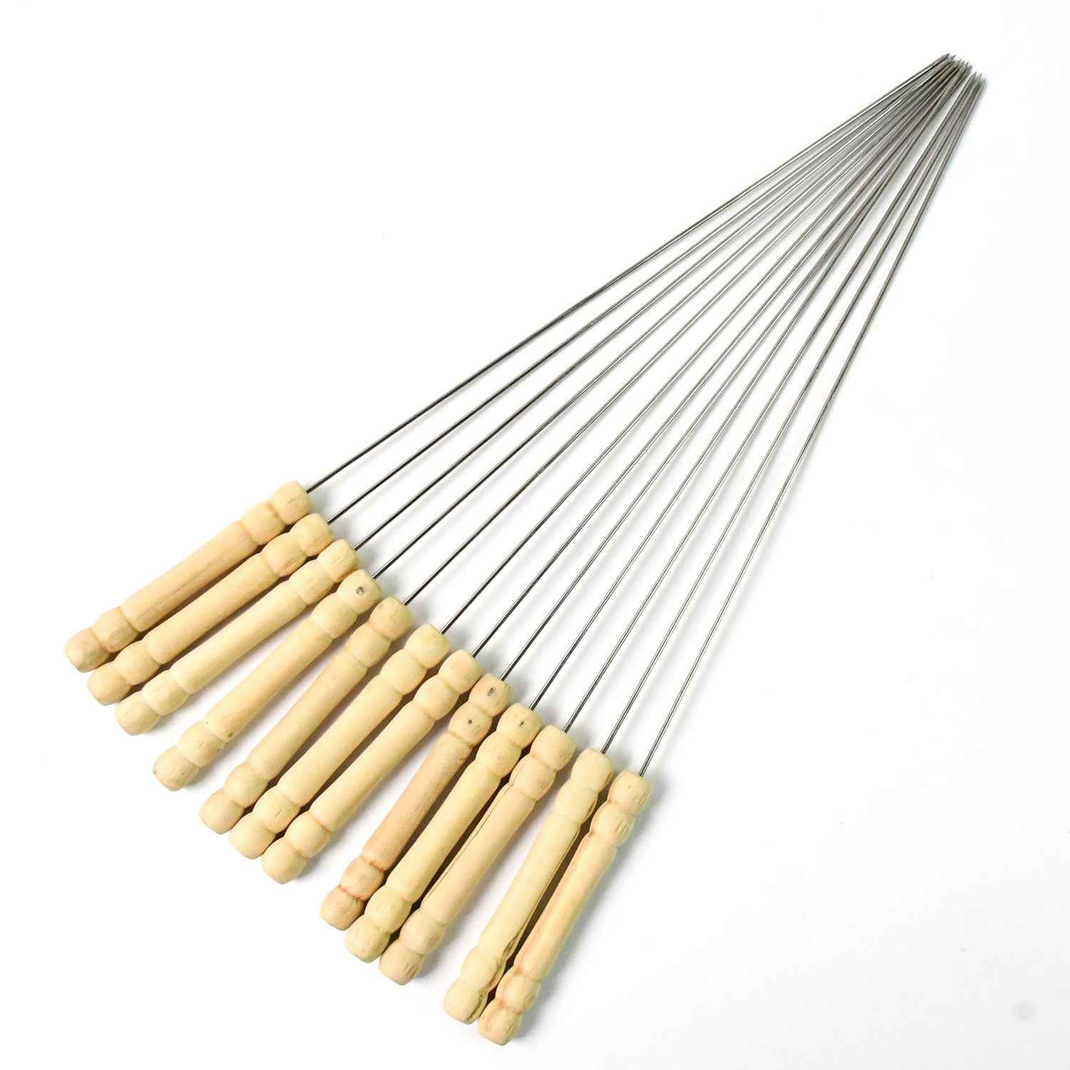 Durable stainless steel skewers laid out ready for grilling on a barbecue.
