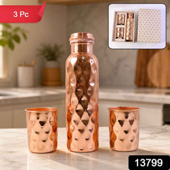 The elegant copper water bottle and two glasses, presented as a thoughtful gift set.