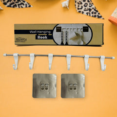 The utensil hanger rail mounted on a kitchen wall, neatly holding various kitchen ladles and tools.