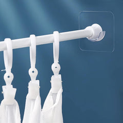 Adhesive curtain rod holder in use on wall for curtains or towels