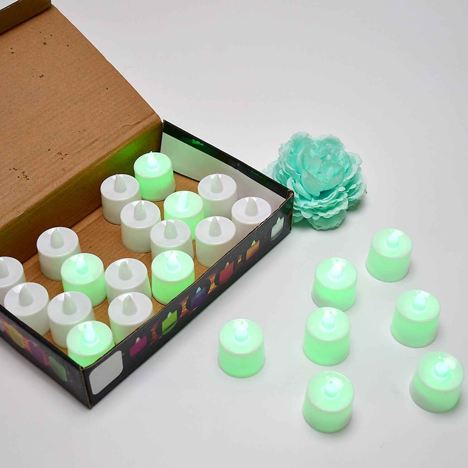 A pack of 24 green flameless LED tealights ready for use.