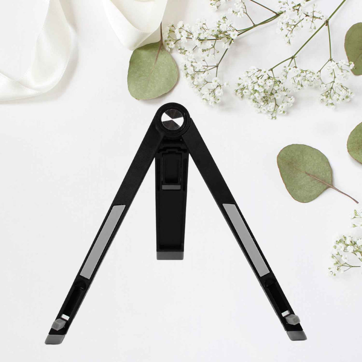 A sleek black foldable tablet stand holding a tablet at an ergonomic viewing angle.