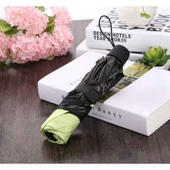 A compact Magic Umbrella folded neatly, highlighting its portable travel size.