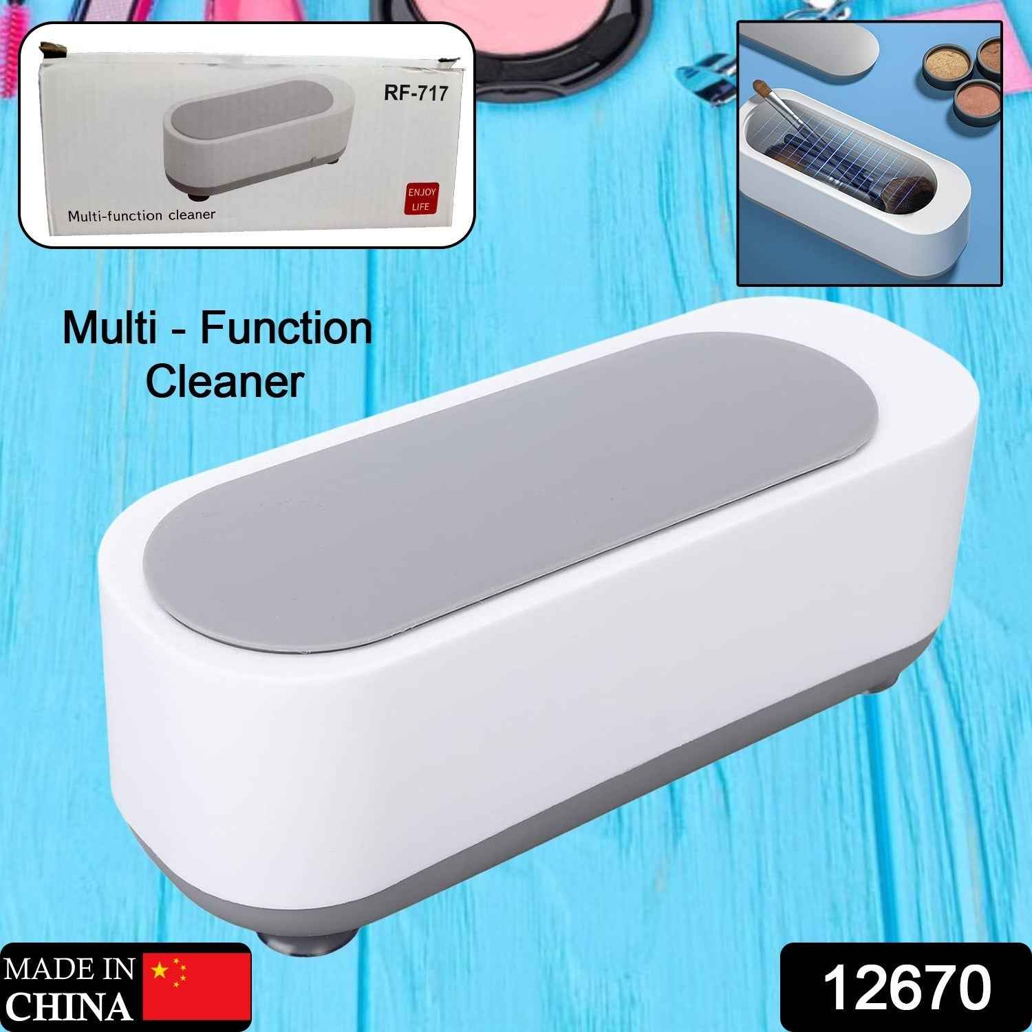 Ultrasonic jewellery cleaner actively cleaning a watch and several rings.
