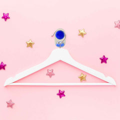 Colorful plastic ball-shaped wall hook holding bathroom towel