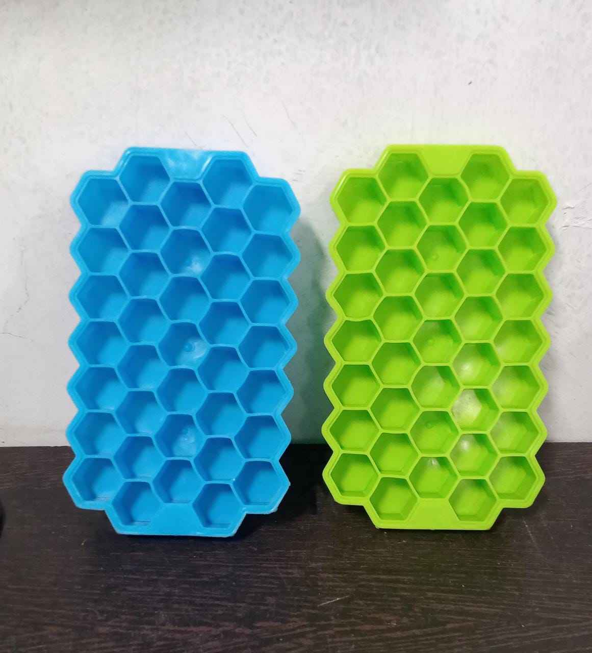 Colorful silicone ice cube tray with honeycomb design for easy release.