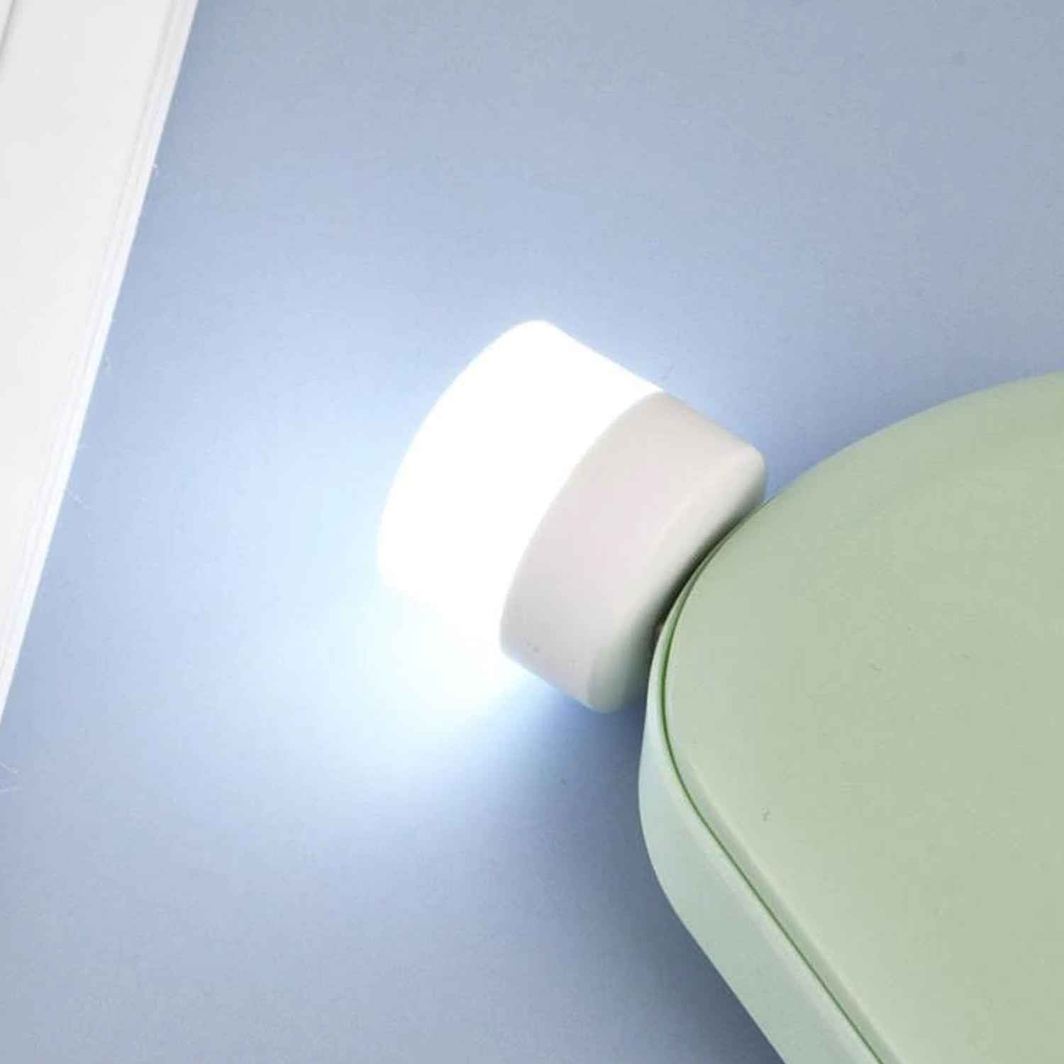 The small USB LED night light shown in hand, highlighting its portability.