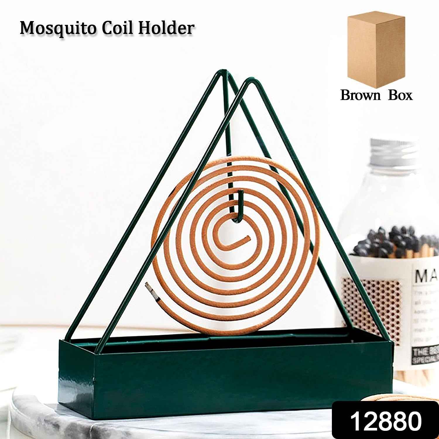 Hand placing a mosquito coil securely inside the decorative iron holder.