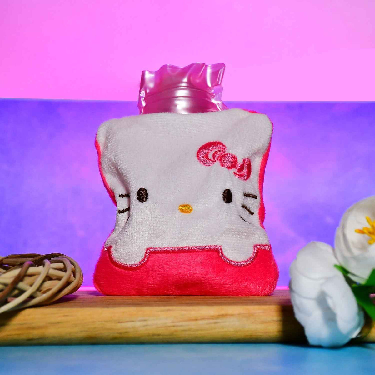 Pink hot water bag with a soft cover, ready for pain relief.