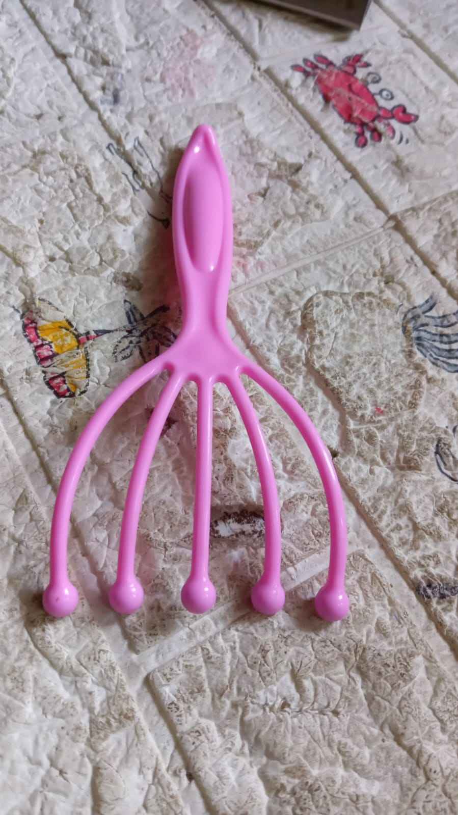 AuriGlam handheld scalp massager shown in its retail packaging.