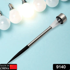 A silver solar LED spike light with a black ground stake is displayed on a light blue background with glowing bulbs.