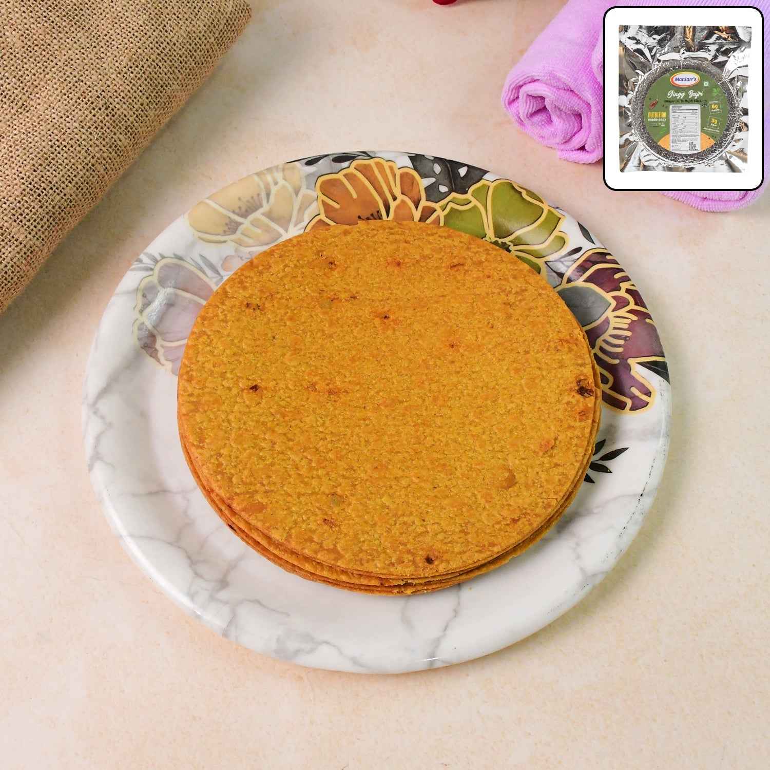 Crispy Maniarr's Bajri Khakhra with ginger garlic flavor on a white plate, golden texture visible.