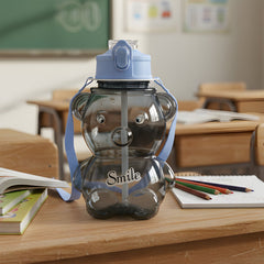 Transparent kids water bottle with cartoon bear design and flip-lock lid