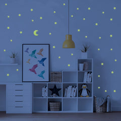 Close-up view of a luminous star wall decal, showing its bright glow in a dark room.