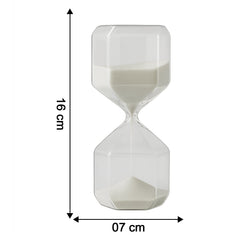 Close-up of glass timer with fine white sand flowing inside for precise visual countdown