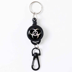 Durable retractable keychain securely clipped onto a fabric strap.